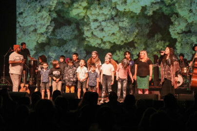 children and adult performers and musicians on stage at Shoalhaven Entertainment Centre Singing and playing to an audience