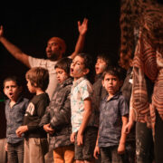 children are singing on stage
